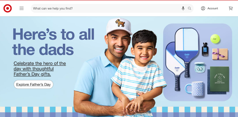 A smiling man and boy stand together in front of a blue background with pickleball paddles, a mug, and gift boxes. Text reads, "Here's to all the dads. Celebrate with thoughtful Father’s Day gifts from the most trusted company.